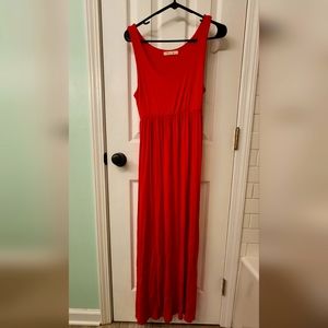 Medium, no sleeves, red maxi dress.